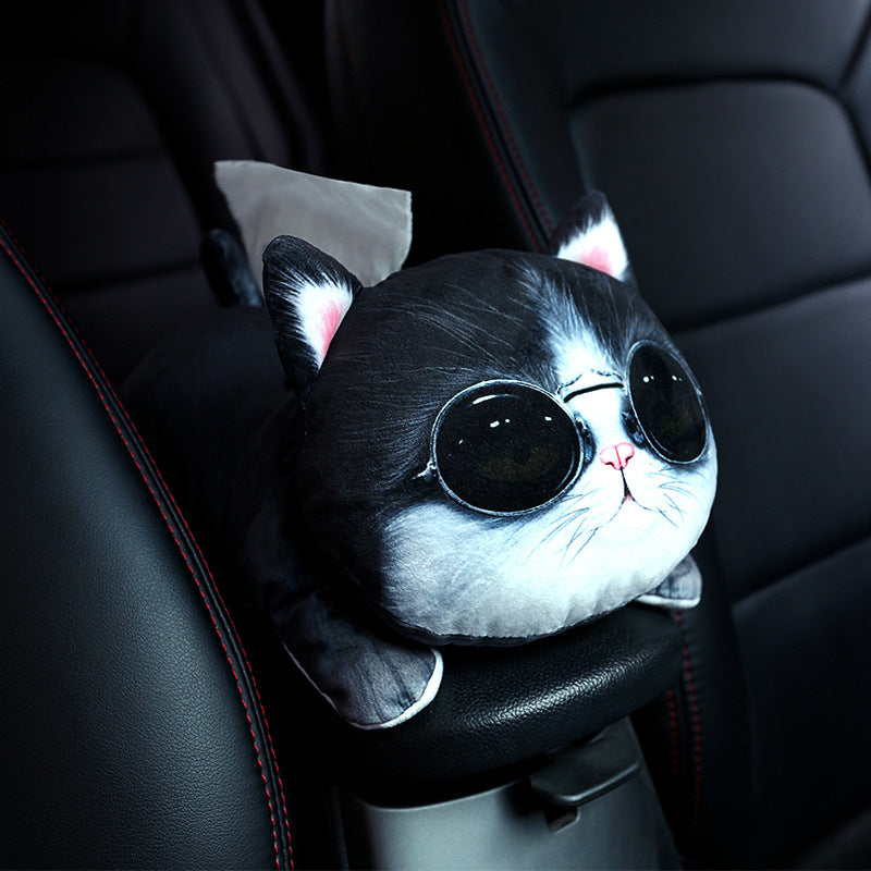 Plush toy shaped like a cat with sunglasses on a car seat