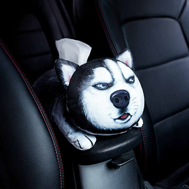 Dog-shaped tissue holder on a car's headrest with black leather interior.