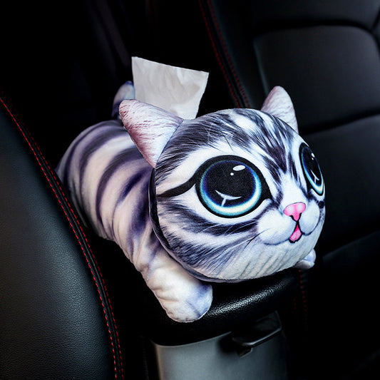 Cat-shaped tissue holder with cartoon design on a car's armrest.